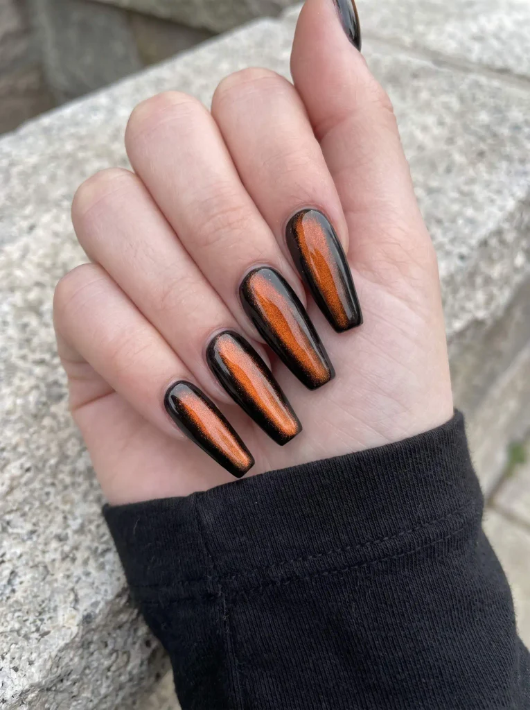 Black and orange cat eye nails