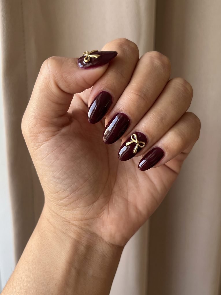 Burgundy and Gold Bow Nails
