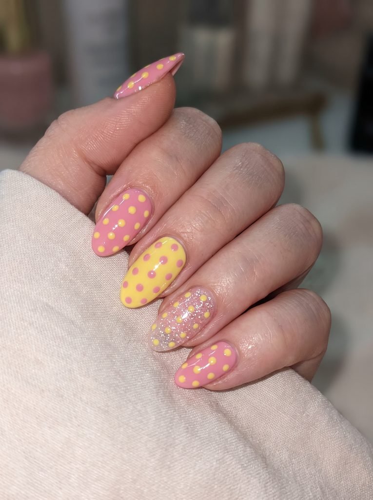 Glitter accent pink yellow dot nails