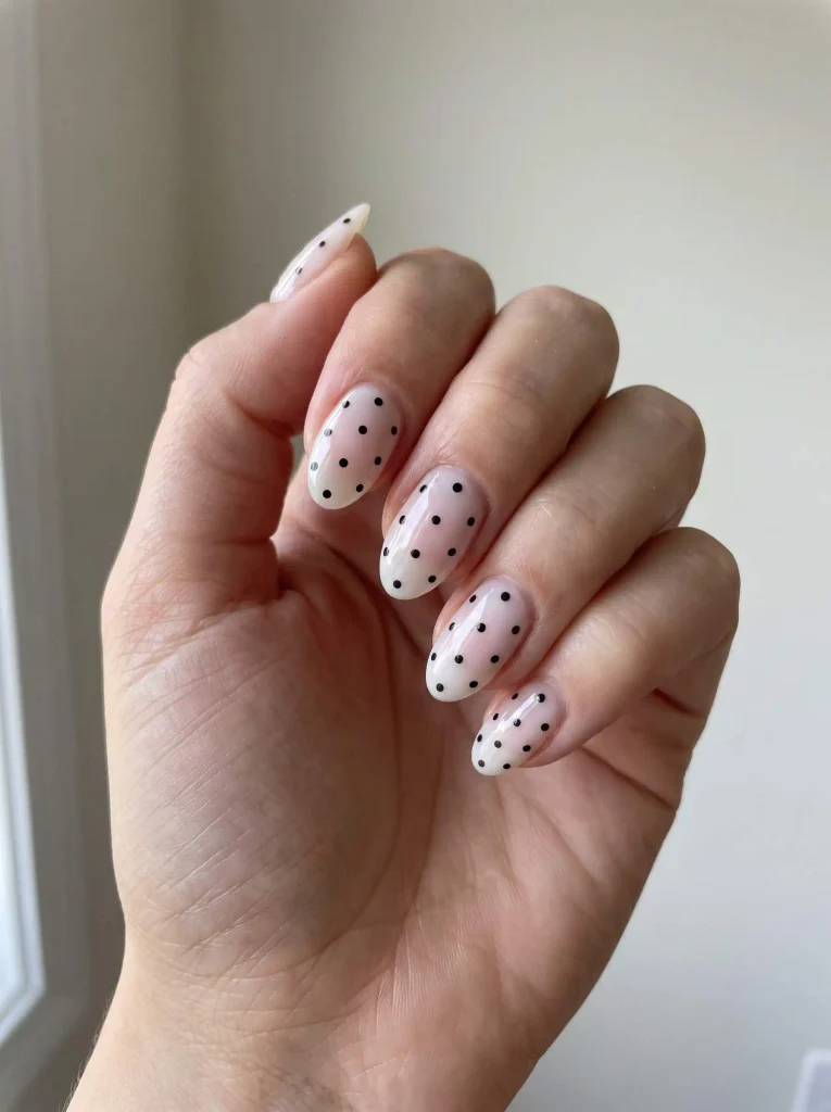Milky white nails with black polka dots