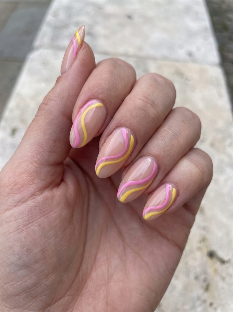 Pink and yellow swirl nails