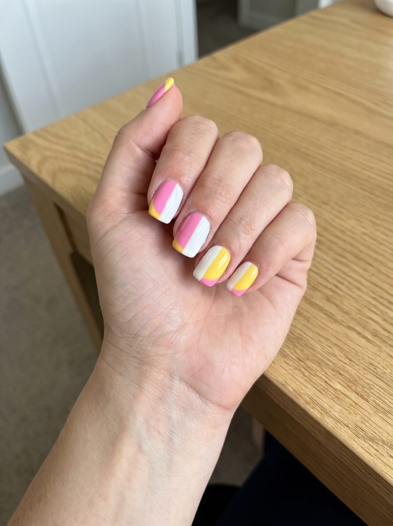 Pink white and yellow nails