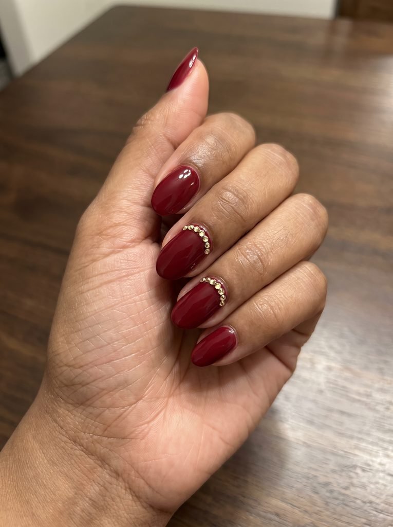 Red Nails With Gold Gem Accents