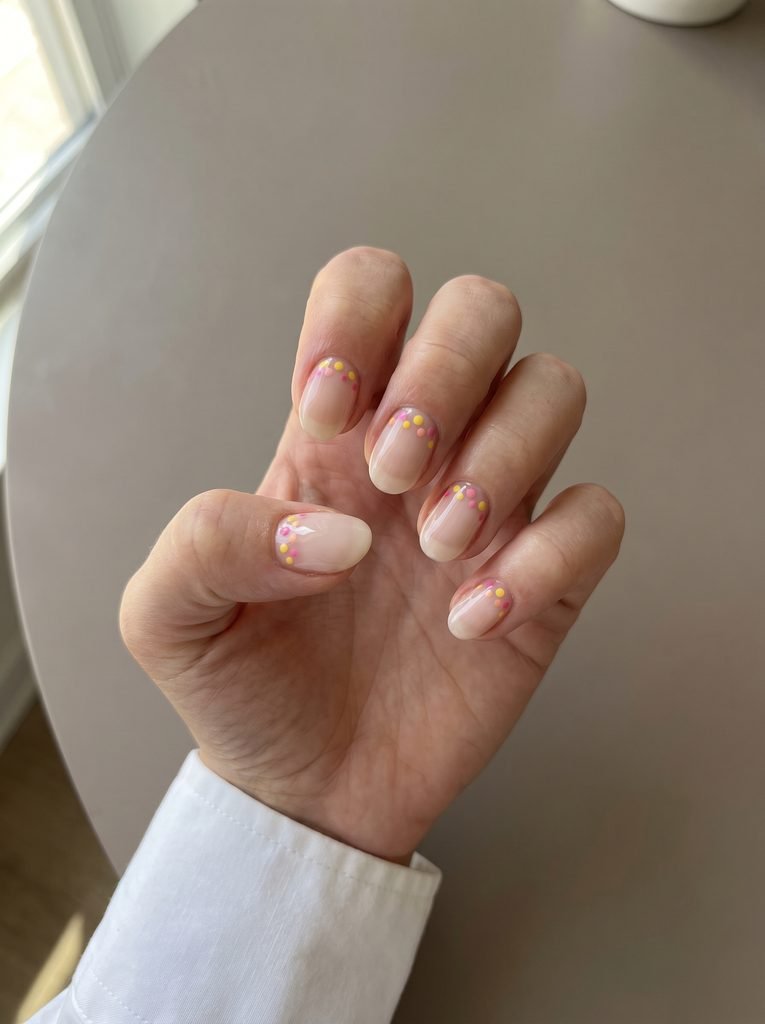 Reverse French pink yellow polka dot nails