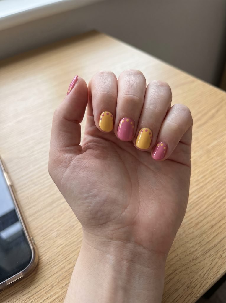 Short pink yellow polka dot nails