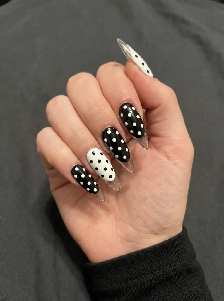 Stiletto black and white polka dot nails