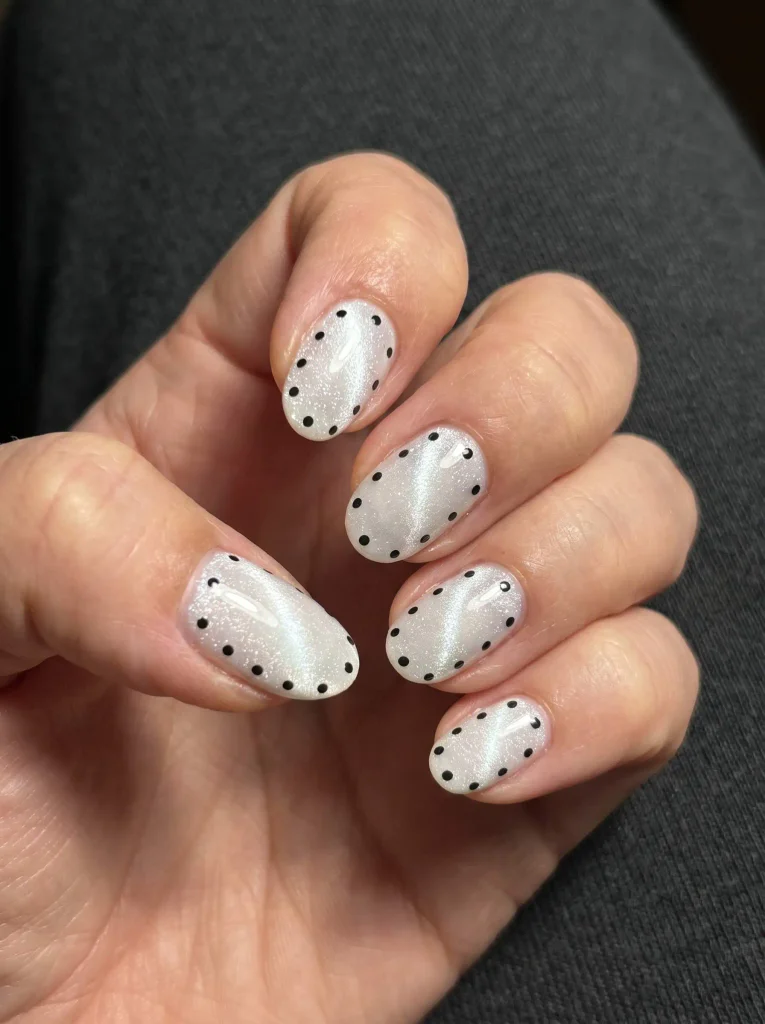 White cat eye black polka dot nails